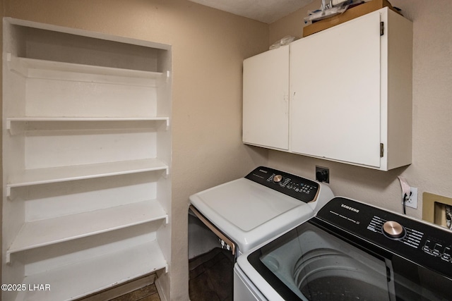 clothes washing area with cabinet space and washing machine and clothes dryer