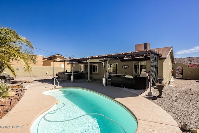 back of property featuring a fenced in pool, a fenced backyard, a patio, and stucco siding