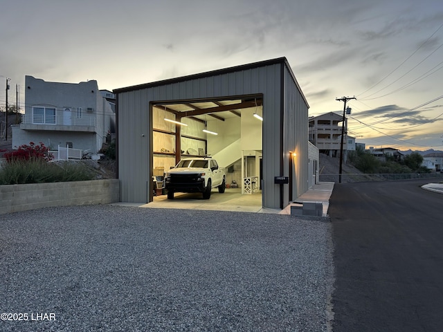 10226 Harbor Dr, Parker, AZ 85344 - outdoor structure at dusk featuring an outbuilding, a garage, and driveway
