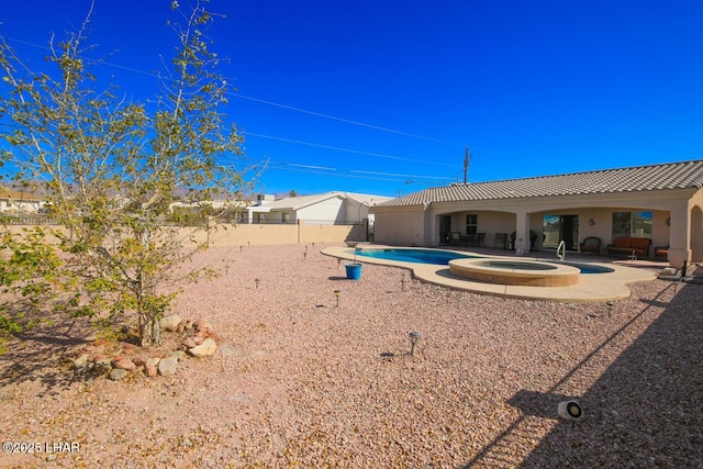 view of yard with a patio and a swimming pool with hot tub