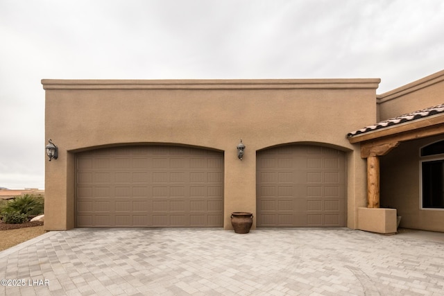 garage featuring decorative driveway