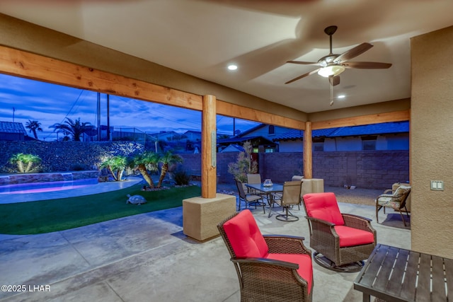 view of patio with outdoor dining space, a fenced backyard, and a ceiling fan