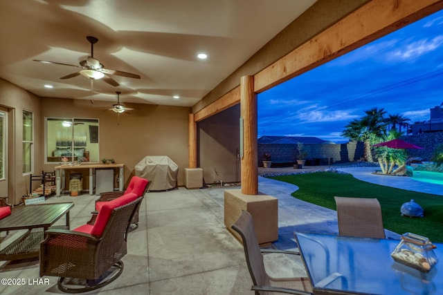 view of patio featuring a ceiling fan, outdoor dining space, and a grill