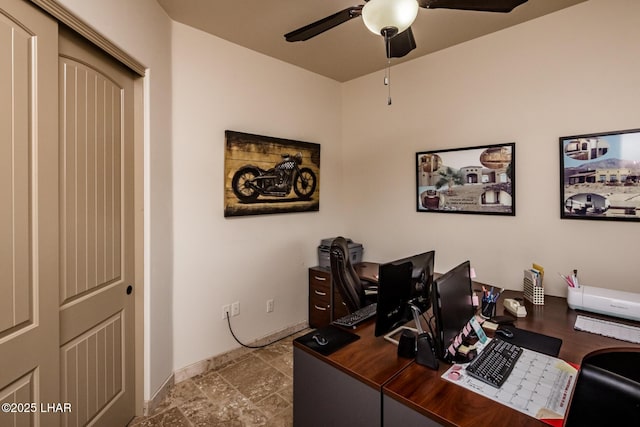 office with a ceiling fan and baseboards