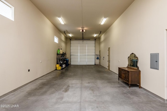 garage with electric panel and baseboards