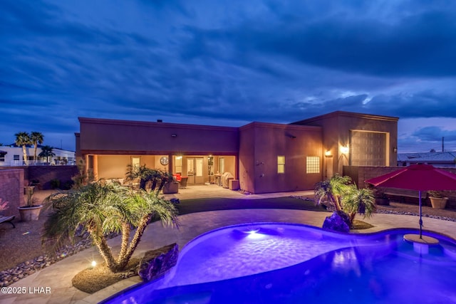 pool featuring a patio area, fence, and a hot tub