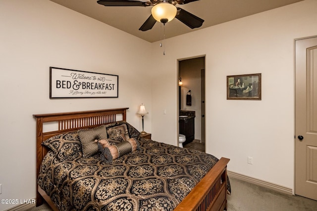 carpeted bedroom featuring ceiling fan, baseboards, and connected bathroom