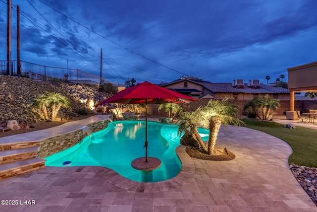 view of swimming pool featuring fence, a fenced in pool, and a patio