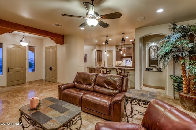 living room featuring a ceiling fan, recessed lighting, visible vents, and arched walkways