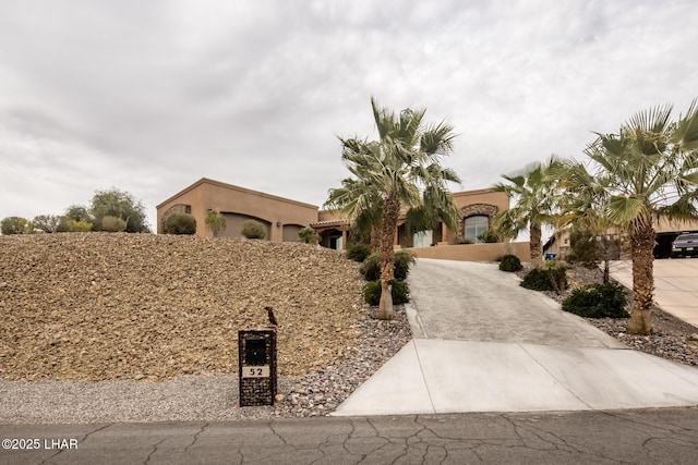 view of front of property featuring driveway and stucco siding