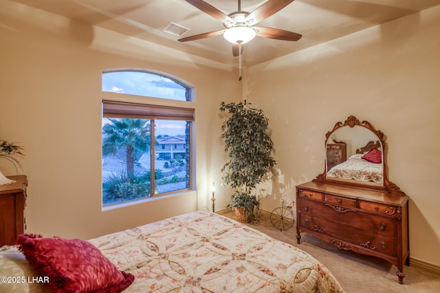 carpeted bedroom with ceiling fan, visible vents, and baseboards