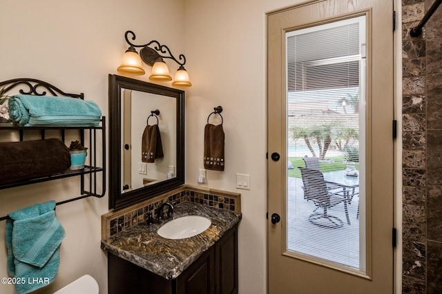 bathroom featuring toilet and vanity