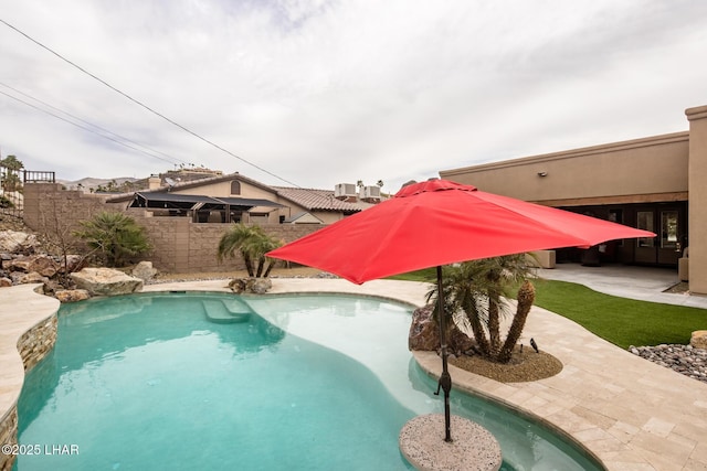 view of swimming pool featuring a fenced in pool, fence, and a patio