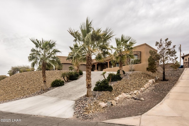 view of front of property featuring driveway and stucco siding