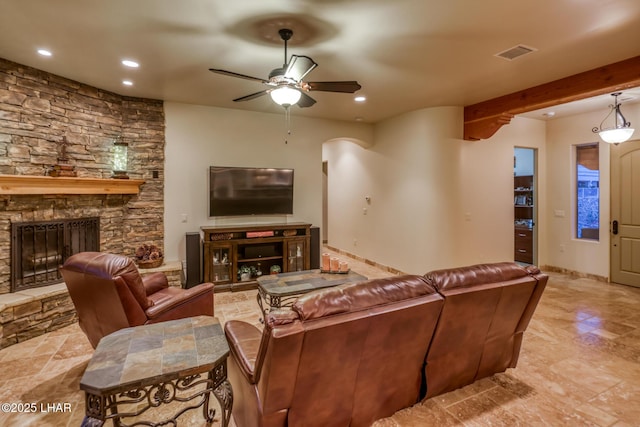 living area featuring a stone fireplace, recessed lighting, visible vents, a ceiling fan, and beamed ceiling