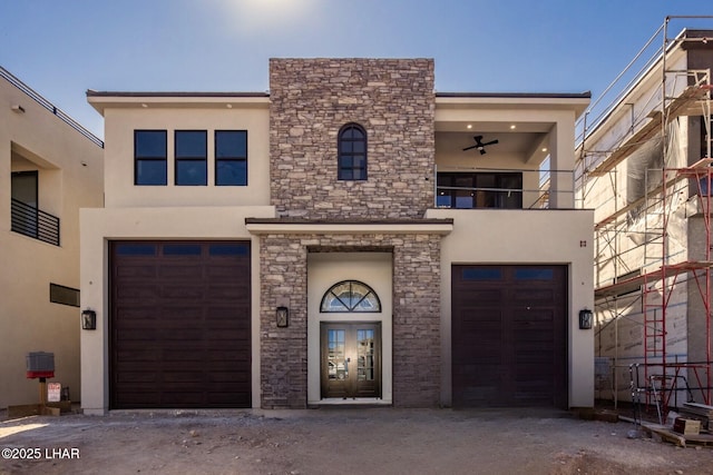 view of front of property with stone siding, a balcony, and stucco siding