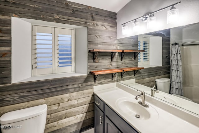 bathroom with vanity, a shower with curtain, toilet, and wood walls