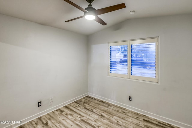 unfurnished room with ceiling fan, vaulted ceiling, and light wood-type flooring