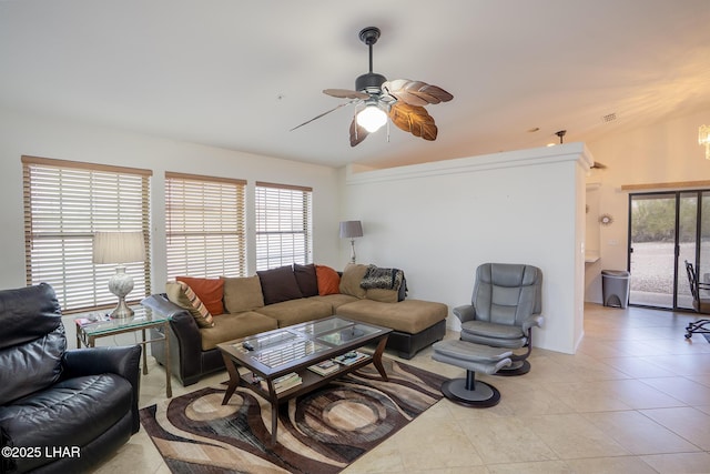 living room featuring light tile patterned floors, a healthy amount of sunlight, and a ceiling fan