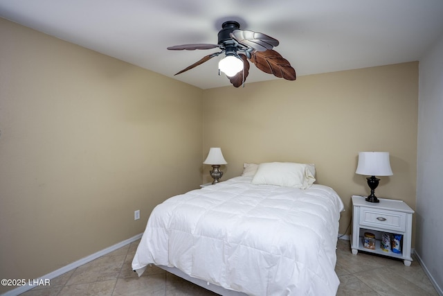 bedroom featuring light tile patterned floors, baseboards, and a ceiling fan