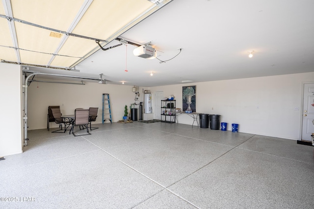 garage featuring a garage door opener and water heater