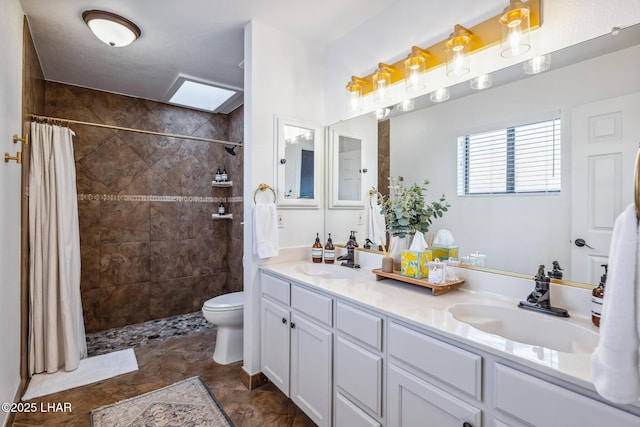 full bath with a sink, double vanity, and tiled shower