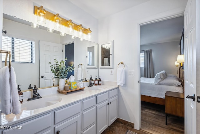 full bathroom featuring ensuite bath, a sink, and plenty of natural light