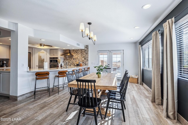 dining space featuring ceiling fan, light wood finished floors, and recessed lighting