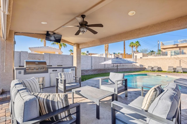 view of patio / terrace featuring an outdoor living space, a fenced backyard, an outdoor kitchen, a fenced in pool, and area for grilling