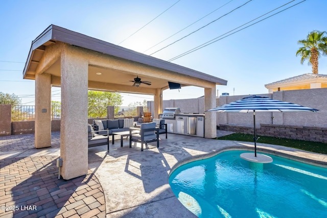 view of swimming pool featuring a fenced backyard, a grill, an outdoor kitchen, a patio, and ceiling fan