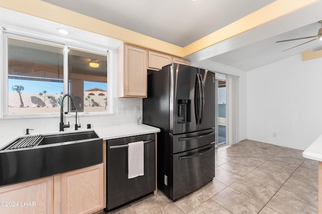 kitchen featuring light brown cabinetry, dishwasher, sink, backsplash, and stainless steel fridge