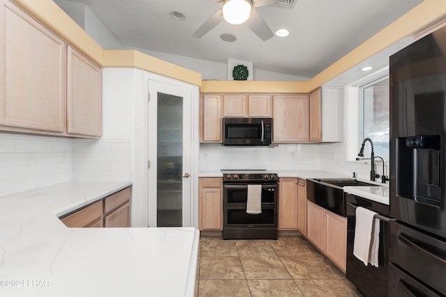 kitchen featuring stainless steel refrigerator with ice dispenser, double oven range, light brown cabinetry, and sink