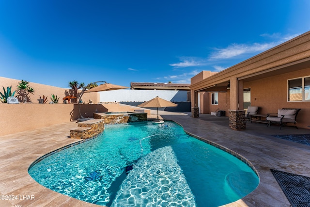 view of pool featuring a patio area and an in ground hot tub