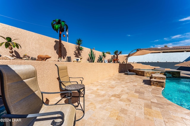 view of patio / terrace with a pool with hot tub