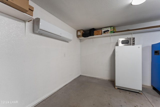 basement with white fridge and a wall mounted air conditioner