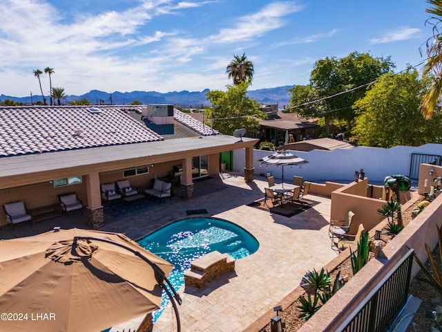 view of pool with a mountain view and a patio area