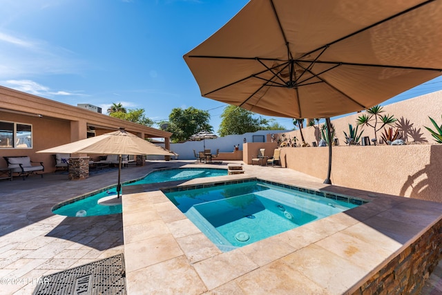 view of swimming pool featuring an in ground hot tub and a patio