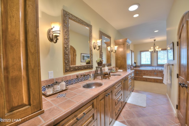 9124 Lakeview Dr, Parker, AZ 85344 - bathroom featuring tile patterned flooring, a notable chandelier, vanity, and a relaxing tiled tub