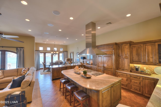 9124 Lakeview Dr, Parker, AZ 85344 - kitchen featuring a center island, island range hood, decorative backsplash, and decorative light fixtures