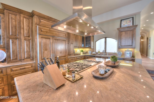 9124 Lakeview Dr, Parker, AZ 85344 - kitchen featuring sink, island range hood, light stone counters, and decorative backsplash