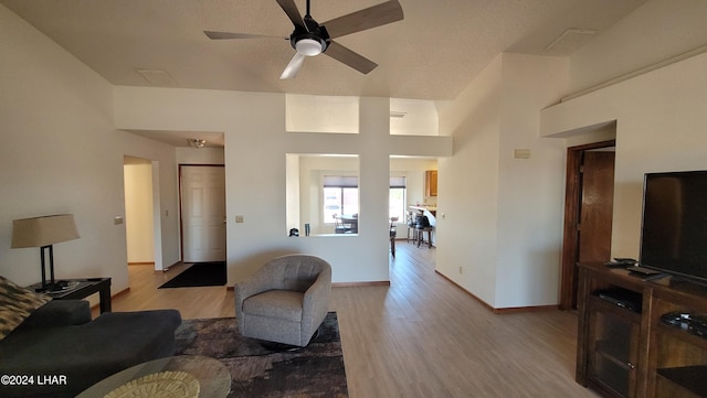 living room featuring ceiling fan and light hardwood / wood-style floors