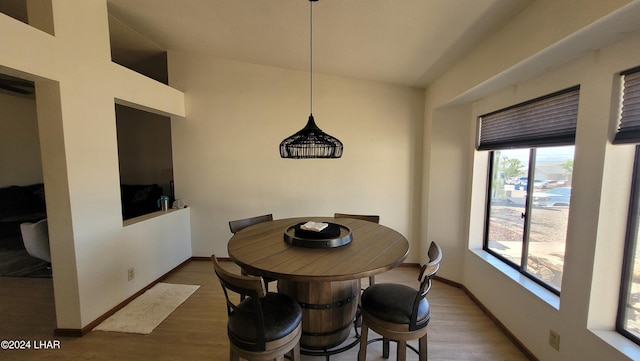 dining area with dark hardwood / wood-style flooring