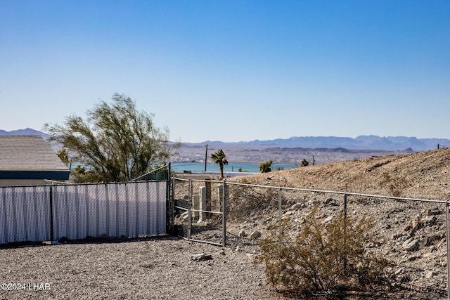 view of yard featuring a water and mountain view