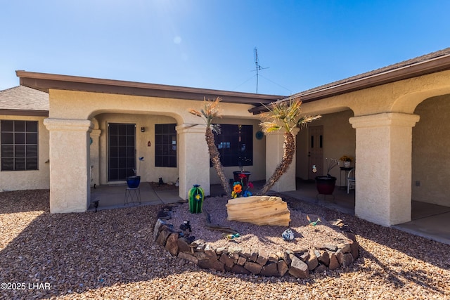 exterior space featuring stucco siding and a patio