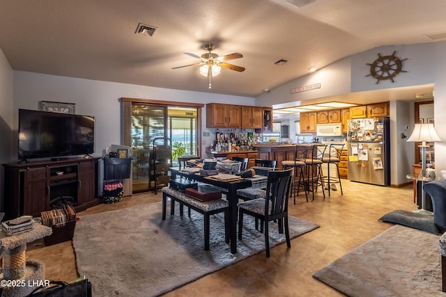 dining area featuring lofted ceiling, visible vents, and ceiling fan