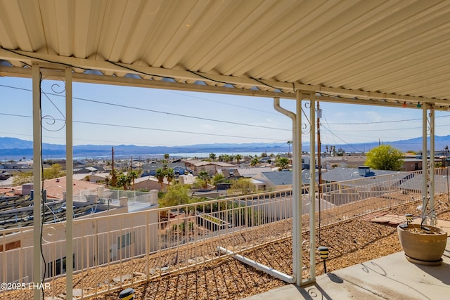 exterior space featuring a residential view, a mountain view, and fence