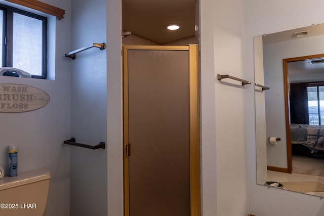 ensuite bathroom featuring toilet, visible vents, a stall shower, and ensuite bathroom