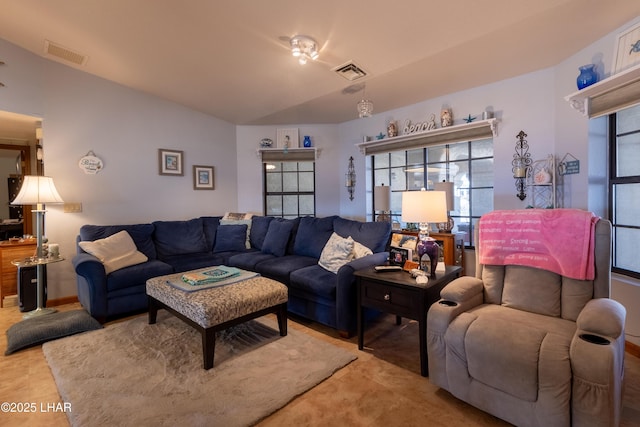 living room featuring vaulted ceiling, a healthy amount of sunlight, and visible vents