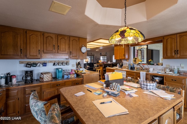 kitchen with brown cabinets, white dishwasher, and light countertops