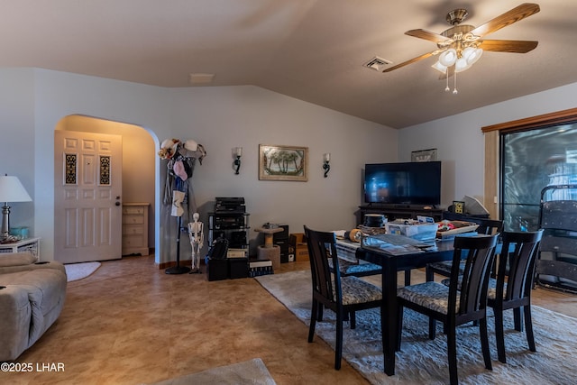 dining area with visible vents, arched walkways, lofted ceiling, and a ceiling fan